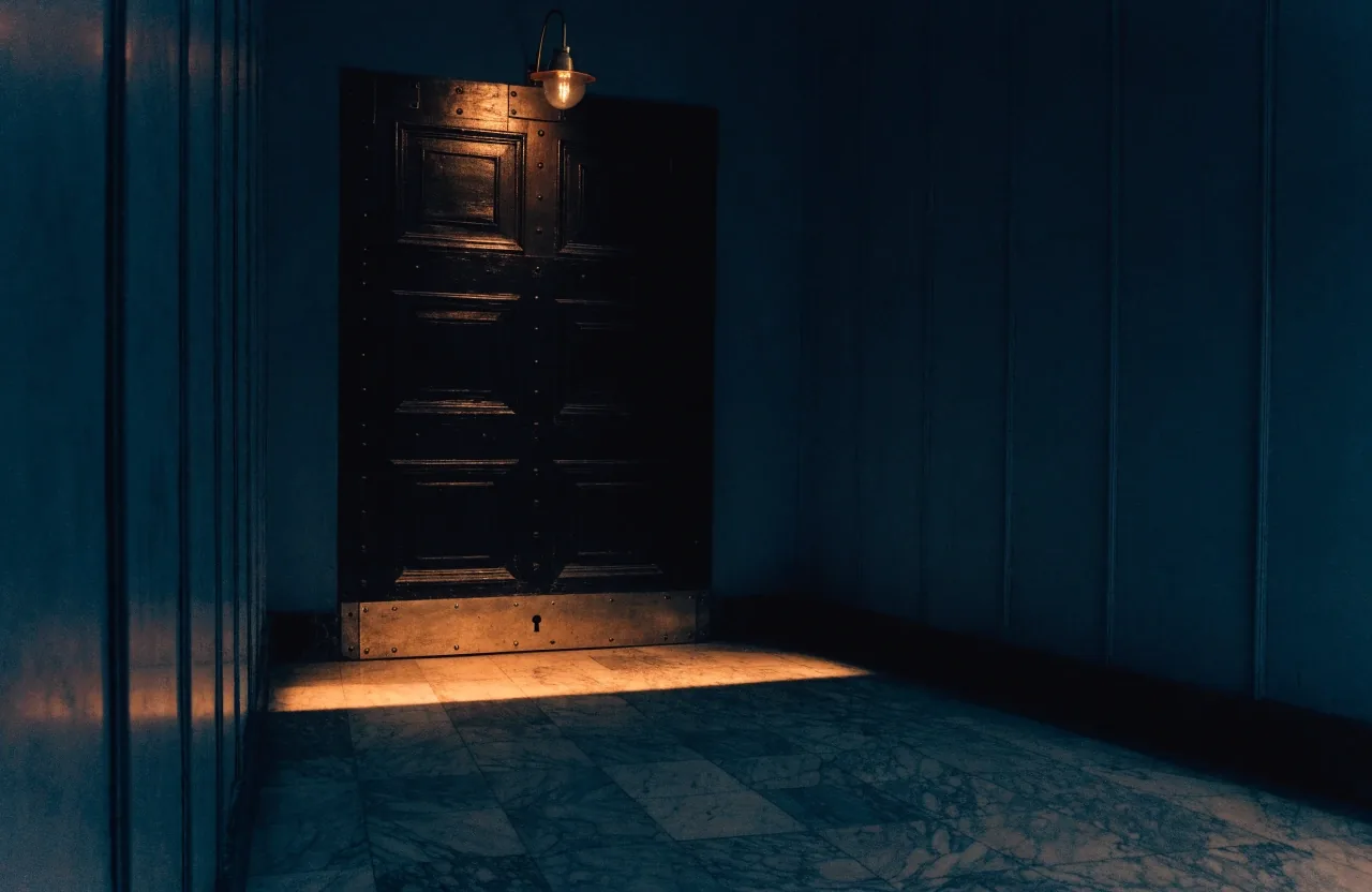 A night corridor in a foreign ministry building, lit by a single band of hard lamplight across the stone floor